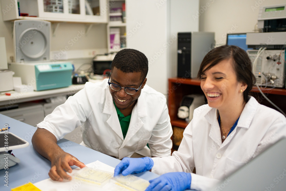 Happy Multiracial Scientists Researching In The Laboratory. Happy Multiracial Scientists Researching In The Laboratory.