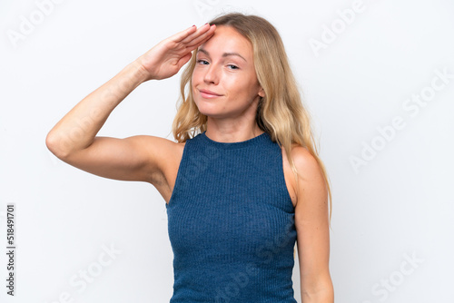 Young Russian woman isolated on white background saluting with hand with happy expression