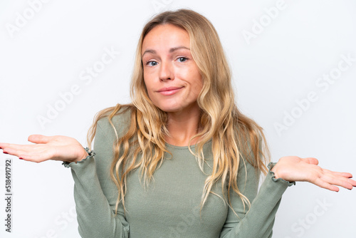 Young Russian woman isolated on white background having doubts while raising hands