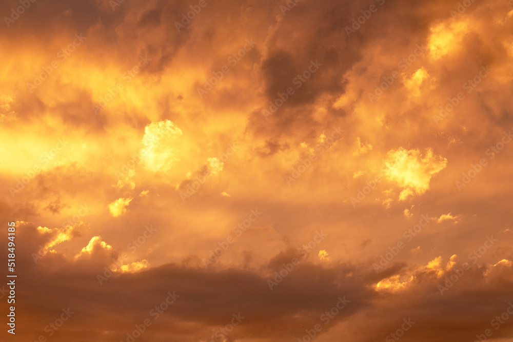 Sunset or dawn sky, yellow clouds with rays and hidden sun. Heaven high. Copy space Sunset or dawn sky, yellow clouds with rays and hidden sun. Heaven high. Copy space