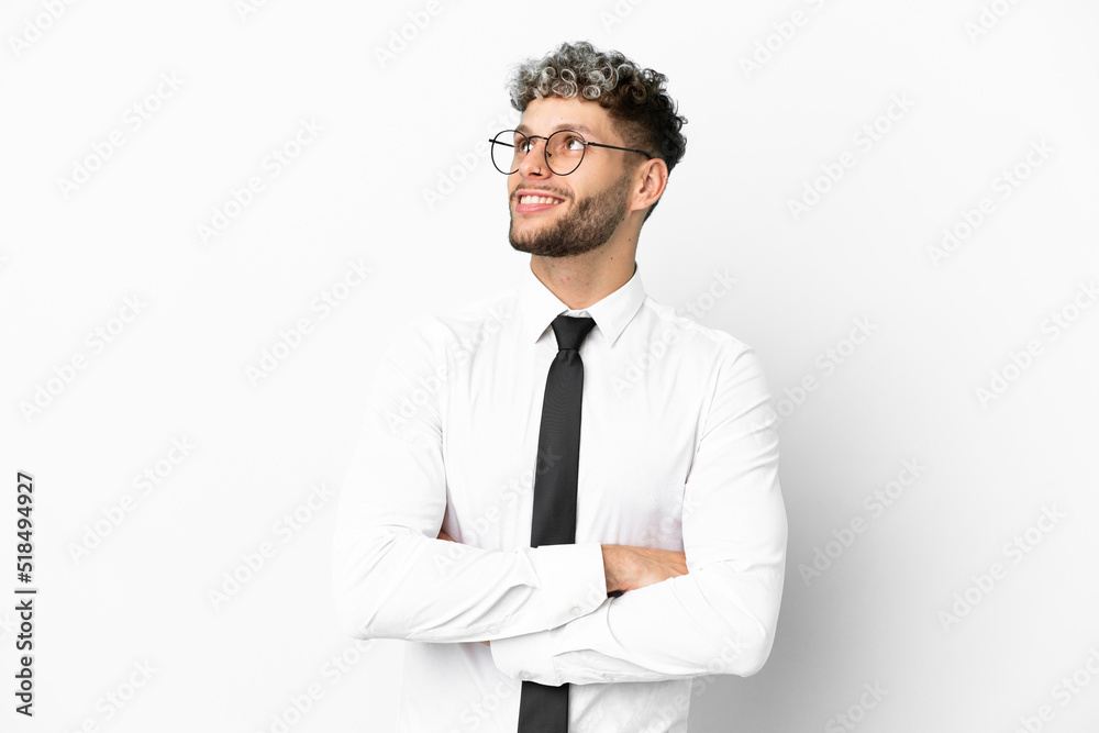 Business caucasian man isolated on white background looking up while smiling Business caucasian man isolated on white background looking up while smiling