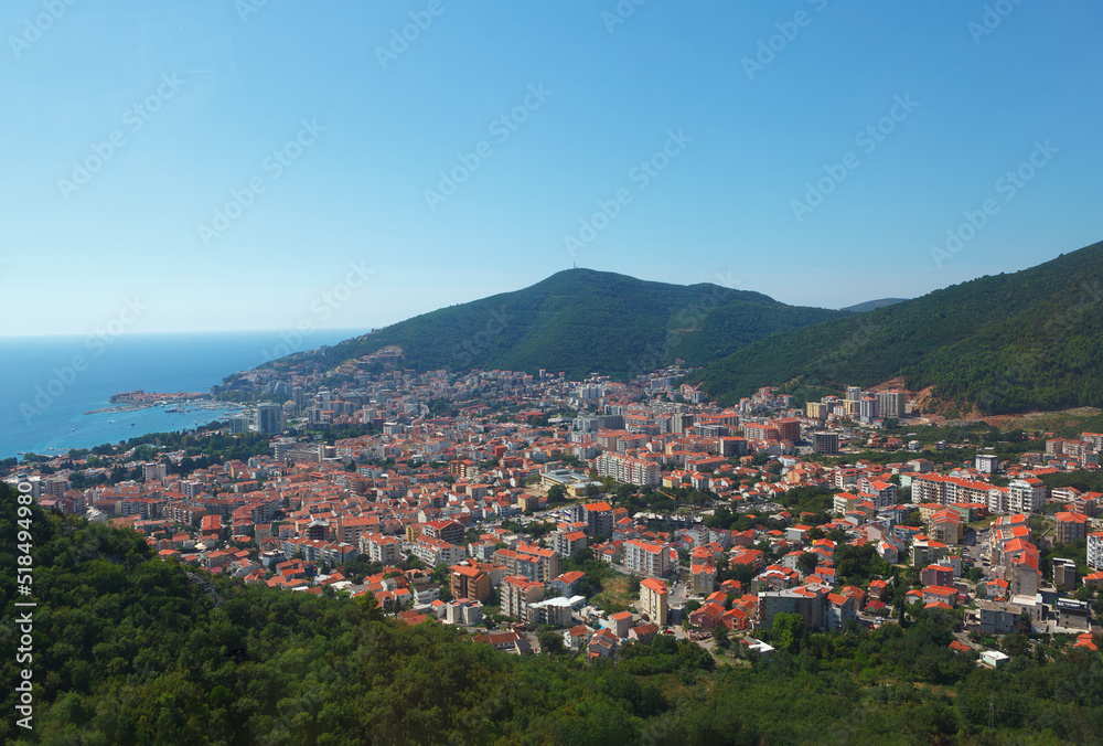 Coastal town surrounded by mountains . Budva city in Montenegro view from above