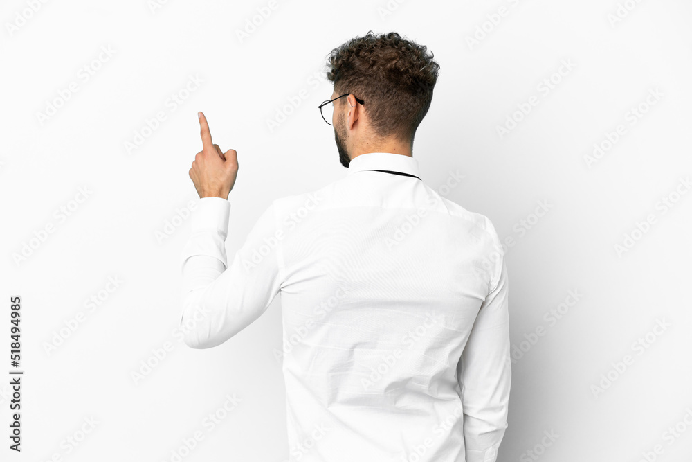 Business caucasian man isolated on white background pointing back with the index finger Business caucasian man isolated on white background pointing back with the index finger