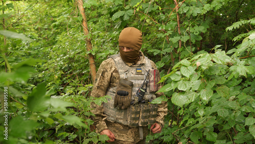 Quadro em tela Ukrainian soldier hides from enemy attack in the forest