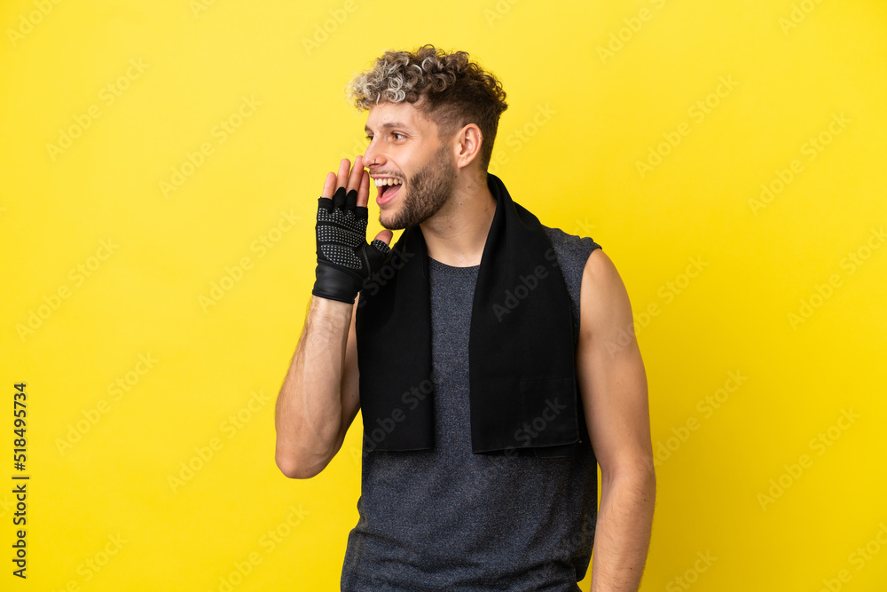 Sport caucasian man isolated on yellow background shouting with mouth wide open to the lateral
