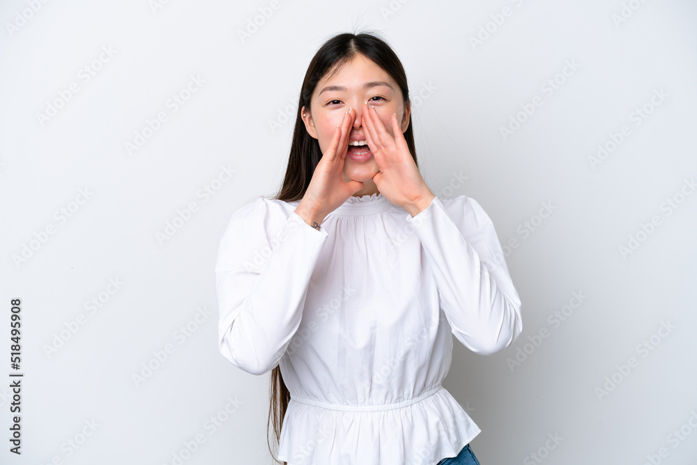 Young Chinese woman isolated on white background shouting and announcing something Young Chinese woman isolated on white background shouting and announcing something
