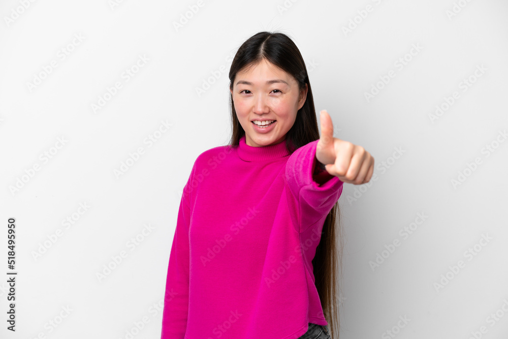 Young Chinese woman isolated on white background with thumbs up because something good has happened Young Chinese woman isolated on white background with thumbs up because something good has happened