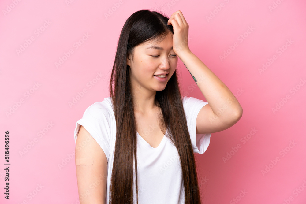 Young Chinese woman wearing a band aids isolated on pink background has realized something and intending the solution Young Chinese woman wearing a band aids isolated on pink background has realized something and intending the solution