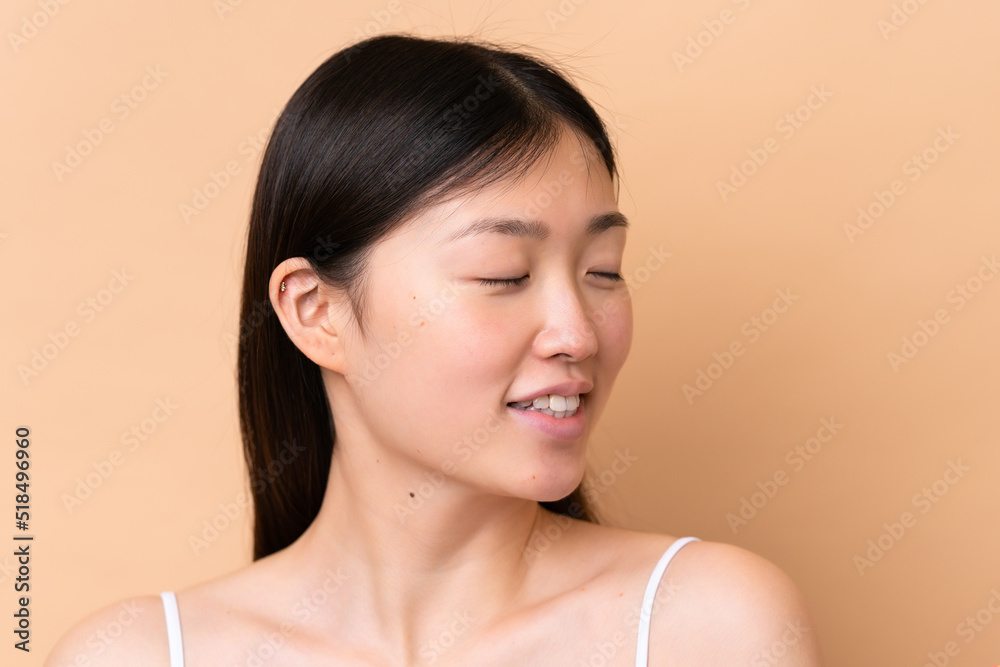 Young Chinese woman isolated on beige background . Portrait Young Chinese woman isolated on beige background . Portrait