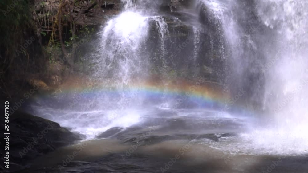 A strong stream of water with rainbow in slowmotion A strong stream of water with rainbow in slowmotion