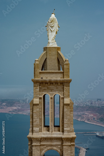 Detail view of blessed virgin mary church from Santa Cruz fortress, one of the three forts in Oran, the second largest port of Algeria; Summer day, looking from high above towards the city. photo