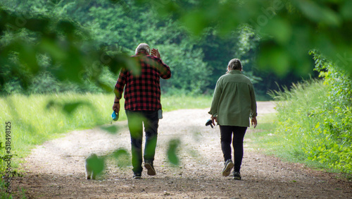 A couple is walking in the forest