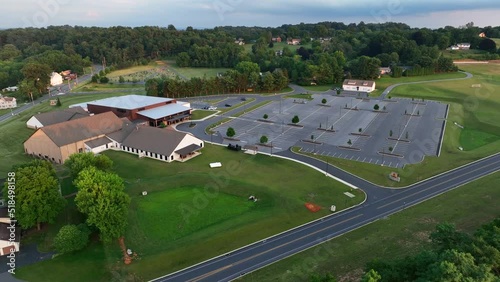 Aerial footage of church. Megachurch with huge building and big parking lot. Religion theme.