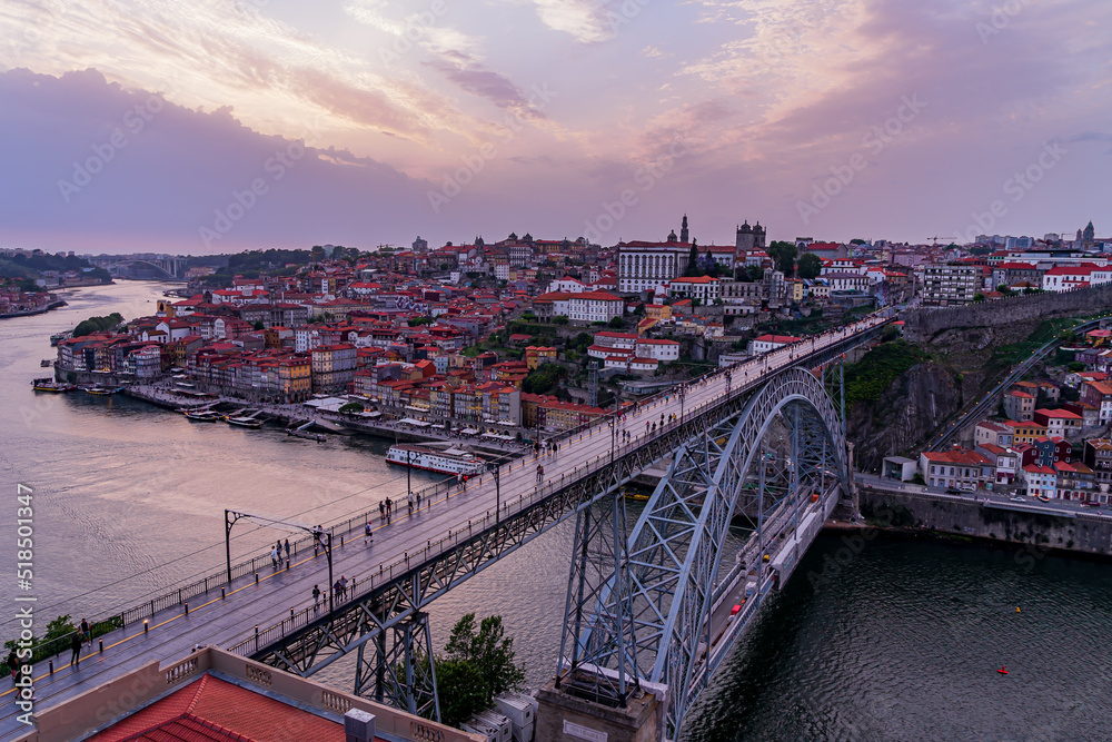 Photo on a cloudy day. Panorama of Porto's old town and the Dom Luis Bridge over the Douro River. Portugal