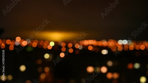 Blurred view of the night city. Evening lights light up the sky.