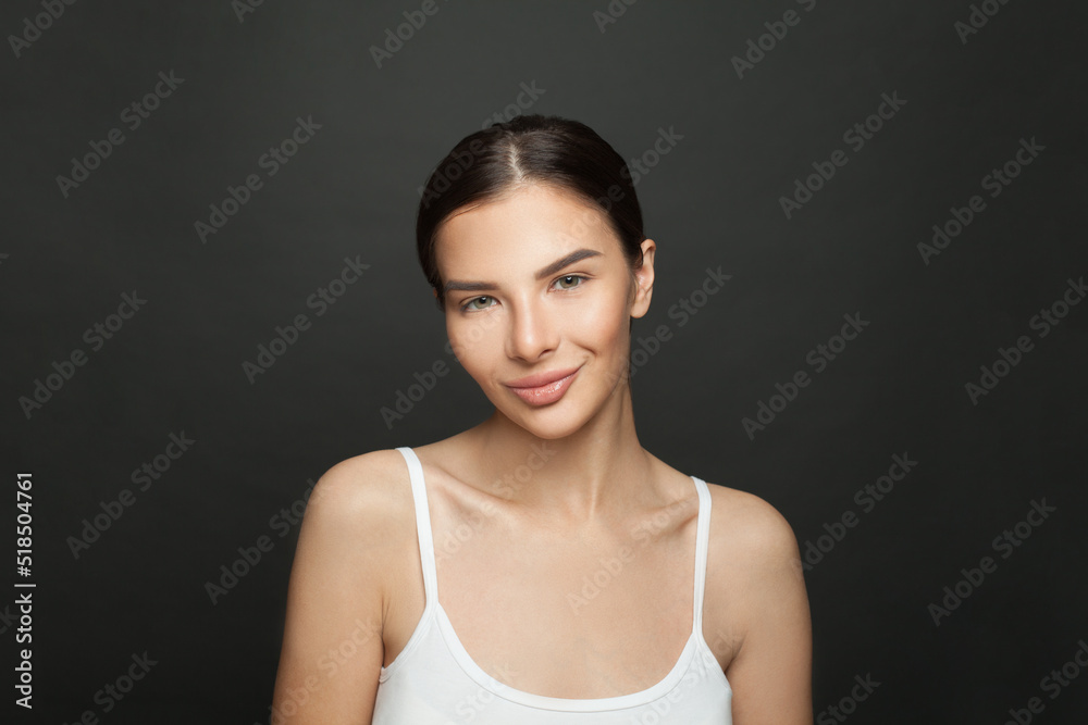 Smiling woman with smooth healthy clean skin on black background portrait Smiling woman with smooth healthy clean skin on black background portrait