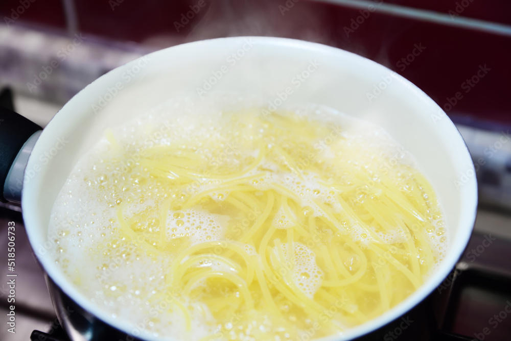 Cooking pasta in saucepan on stove, closeup Cooking pasta in saucepan on stove, closeup