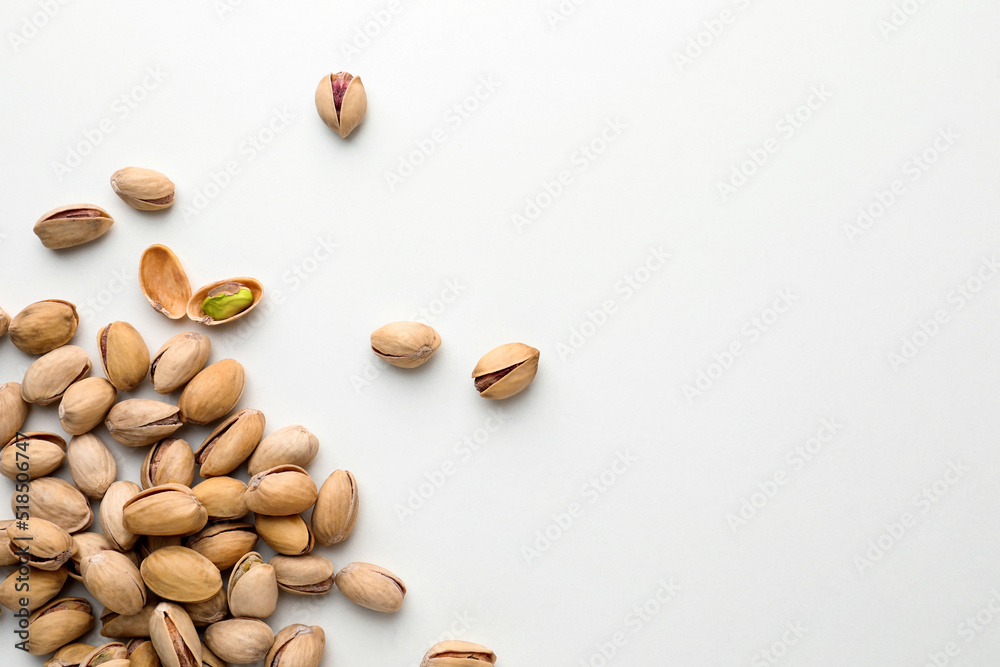 Pile of pistachio nuts on white background, flat lay. Space for text Pile of pistachio nuts on white background, flat lay. Space for text