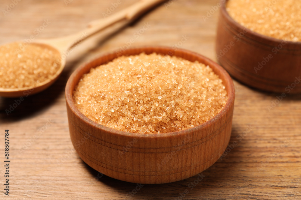 Different dishes with brown sugar on wooden table, closeup Different dishes with brown sugar on wooden table, closeup