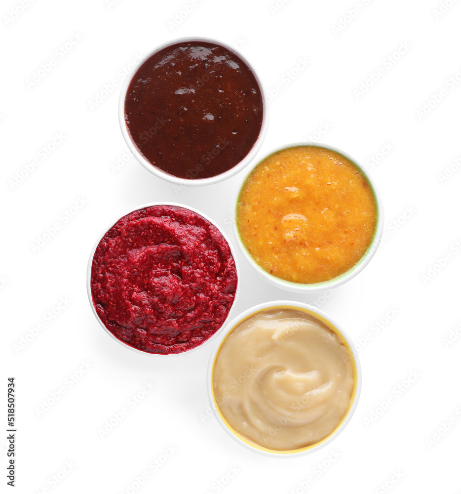 Different fruit and berry puree in bowls on white background, top view Different fruit and berry puree in bowls on white background, top view