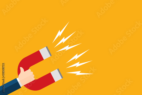 Fotografie Hand of a businessman with magnet