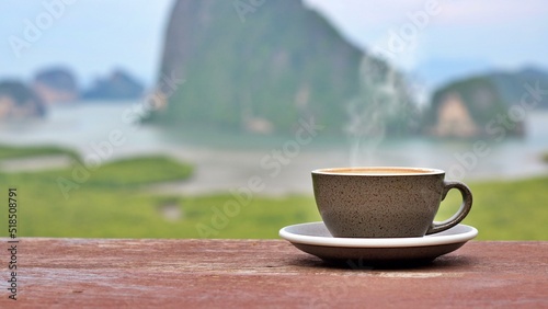 Mug coffee with mountain, Fresh time in a morning day.