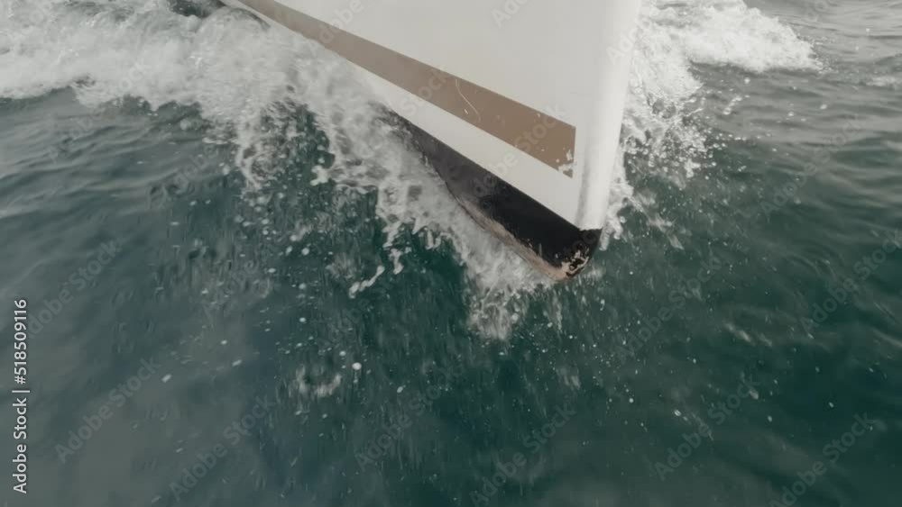 Sharp sailboat stern into the ocean in super slow motion
