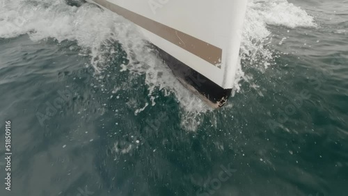 Sharp sailboat stern into the ocean in super slow motion photo