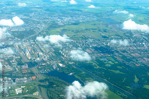 Aerial view of marshlands  modern city and river from airplane. Amsterdam  North Holland  Netherlands
