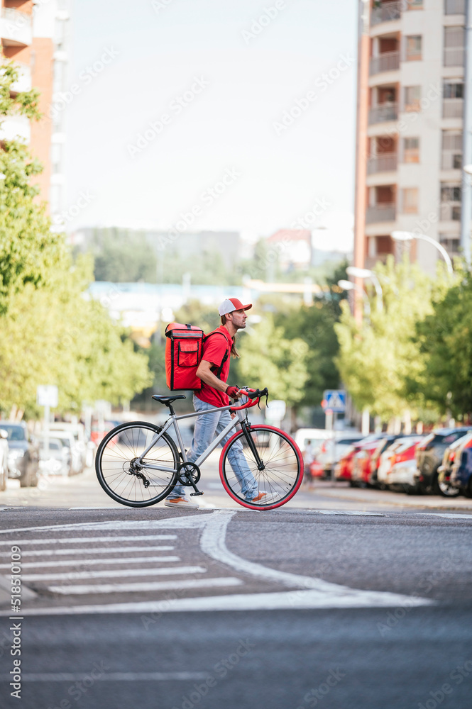 Man who works delivering food by courier at high speed through the city. Man who works delivering food by courier at high speed through the city.