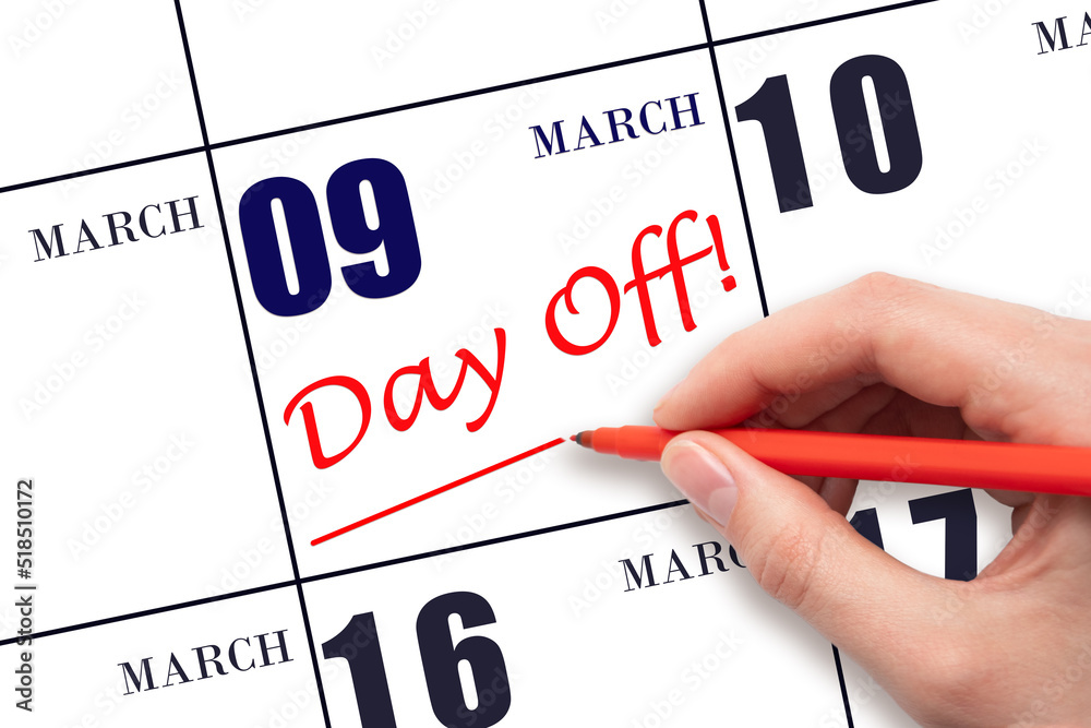 9th day of March. Hand writing text DAY OFF and drawing a line on calendar date 9 March. Vacation planning concept. Spring month, day of the year concept. 9th day of March. Hand writing text DAY OFF and drawing a line on calendar date 9 March. Vacation planning concept. Spring month, day of the year concept.