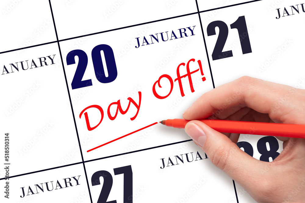 20th day of January. Hand writing text DAY OFF and drawing a line on calendar date 20 January. Vacation planning concept. Winter month, day of the year concept. 20th day of January. Hand writing text DAY OFF and drawing a line on calendar date 20 January. Vacation planning concept. Winter month, day of the year concept.
