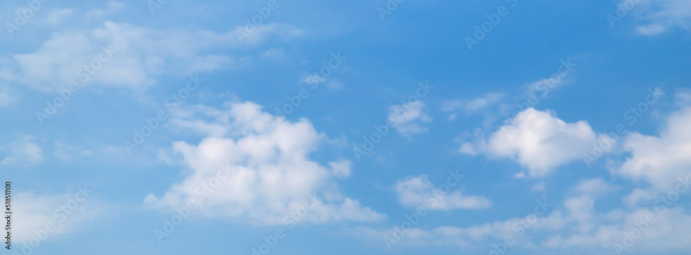 Banner white cumulus clouds on a clear blue sky.