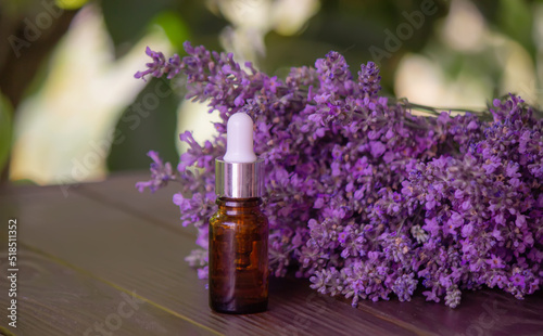 Essential oil of lavender  on a wooden background.