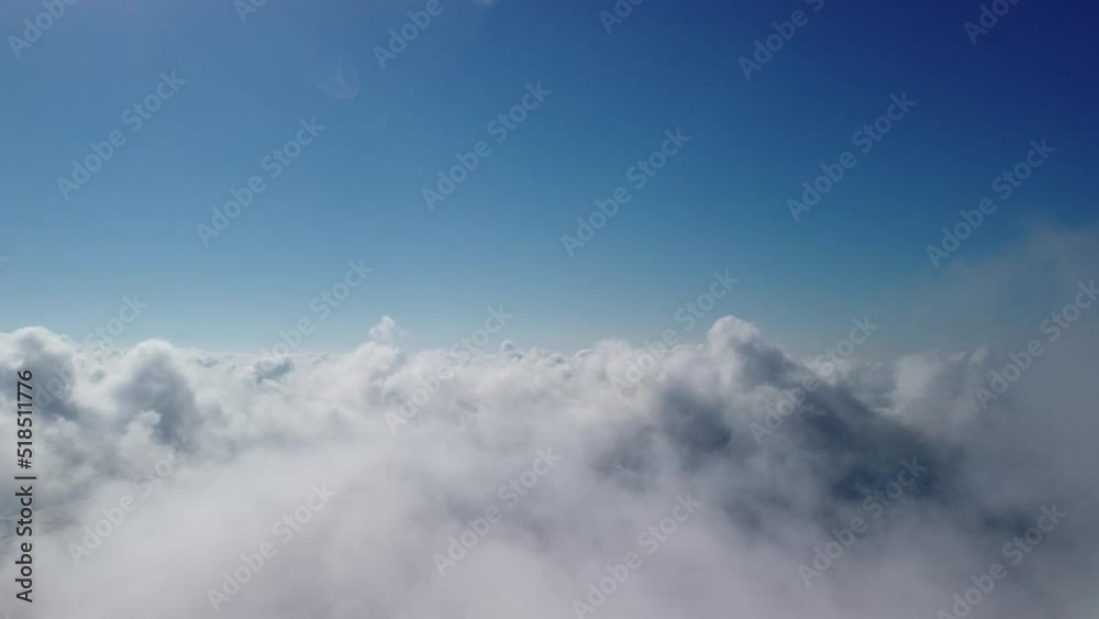 Aerial view. The drone flies over foggy and fluffy clouds. Blue sky sun and sea fog. Abstract aerial nature summer ocean sunset sea and sky background. Vacation, vacation and holiday concept Aerial view. The drone flies over foggy and fluffy clouds. Blue sky sun and sea fog. Abstract aerial nature summer ocean sunset sea and sky background. Vacation, vacation and holiday concept