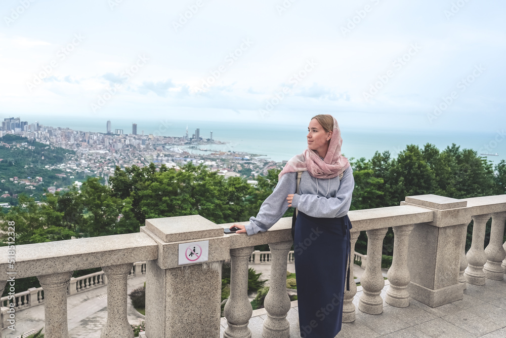 Traveler in the mountains, Panorama of the city at the foot of the mountain. Travel in the mountains, holidays in the mountains, hiking Traveler in the mountains, Panorama of the city at the foot of the mountain. Travel in the mountains, holidays in the mountains, hiking