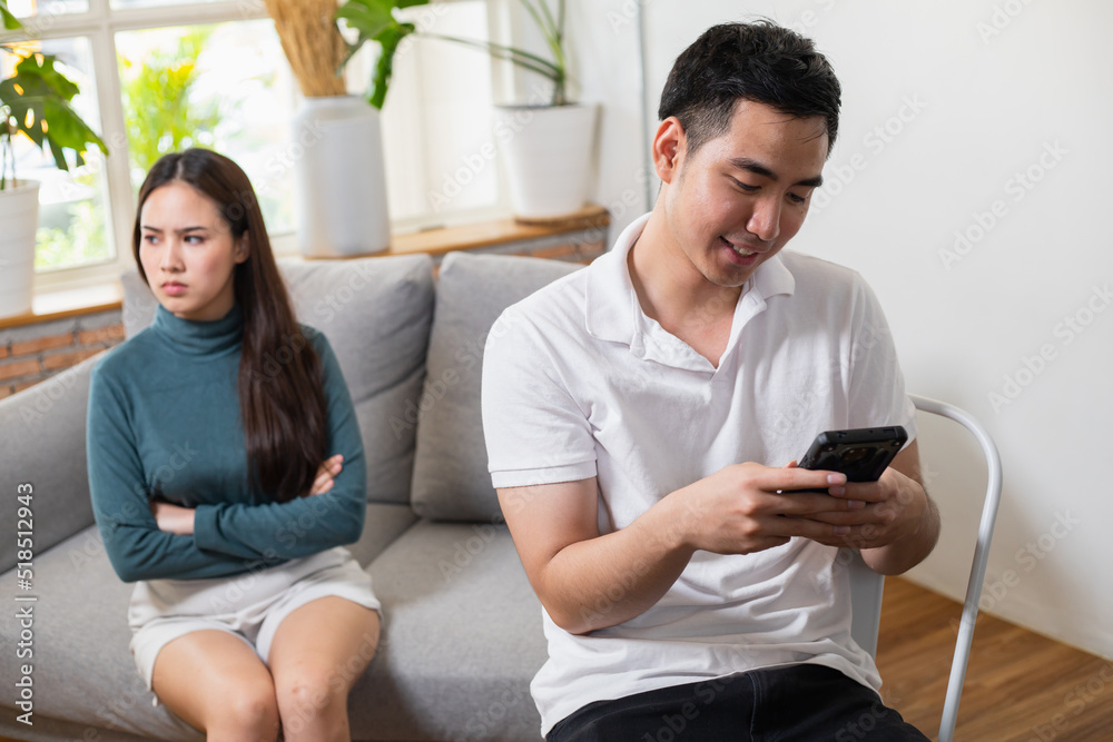 Young Asian couple at the man's side dishonest and disrespectful to his wife. His wife's face was filled with indignation. Young Asian couple at the man's side dishonest and disrespectful to his wife. His wife's face was filled with indignation.