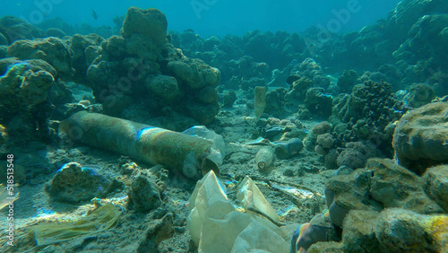 Seabed of beautiful coral reef covered with plastic and other garbage, Red sea, Egypt
