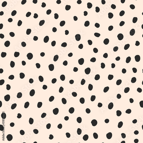 Cute black hand drawn polka dot on beige background. Vector seamless jumble brush spots pattern. Random dots, circles, animal skin. Design for fabric, wallpaper, textile, wrapping paper, packaging.