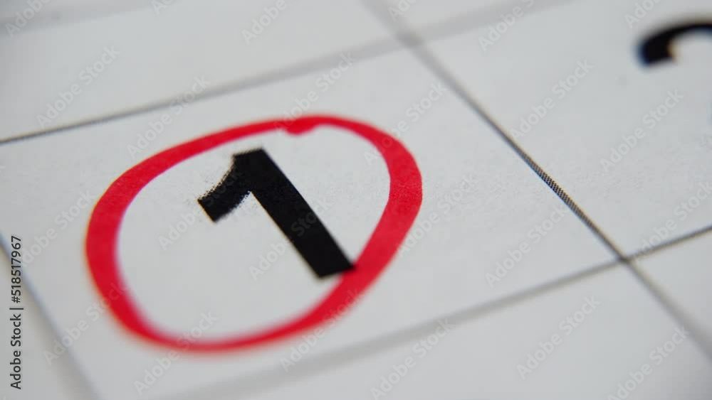 The calendar 1st day of the month is circled. A red marker circles the first day of the paper calendar. A very important date in the calendar The calendar 1st day of the month is circled. A red marker circles the first day of the paper calendar. A very important date in the calendar