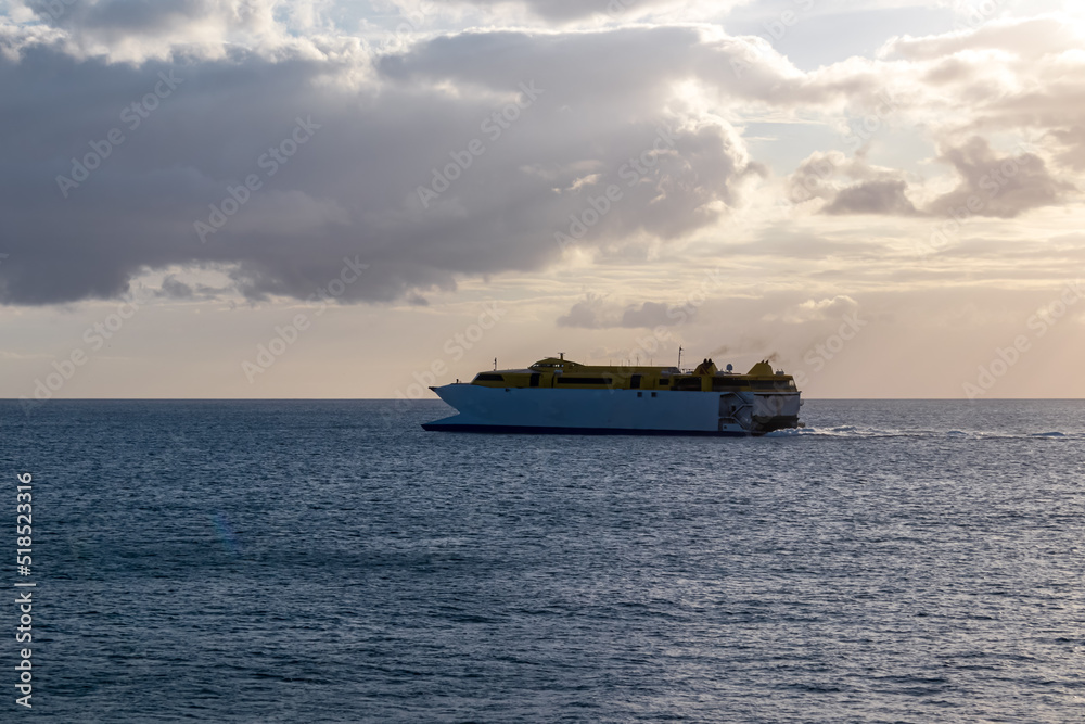 Romantic sunset seen from lookout Cypelek Los Cristianos, Tenerife, Canary Islands, Spain, Europe. Silhouette of regular ferry boat leaving from the harbour towards Island of La Gomera. Island hopping Romantic sunset seen from lookout Cypelek Los Cristianos, Tenerife, Canary Islands, Spain, Europe. Silhouette of regular ferry boat leaving from the harbour towards Island of La Gomera. Island hopping