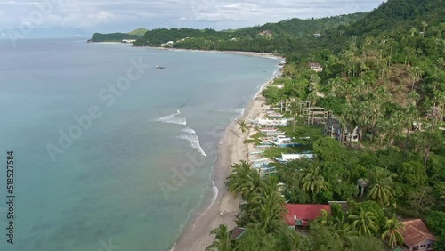 Nice aerial view of beautiful beaches, natural view of the nature seascape, calm sea, cloudy sky, tall green mountains from the Island of Puerto Galera, Philippines photo
