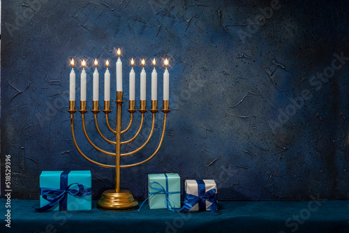 Jewish Hanukkah Menorah 9 Branch Candlestick, gift box. Holiday Candle Holder. Nine-arm candlestick. Traditional Hebrew Festival of Lights candelabra. Background for design with copy space photo