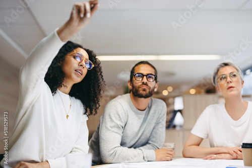 Smart businesswoman sharing her ideas with her team