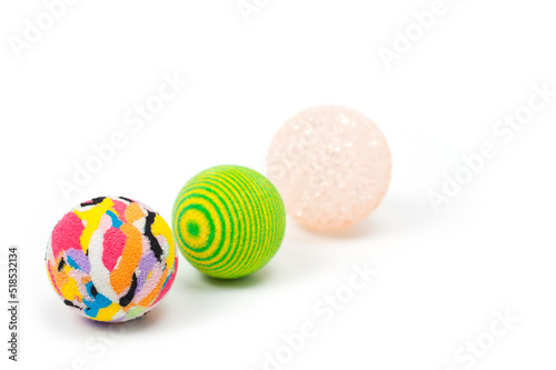 Several plastic and rubber balls for playing with pets.