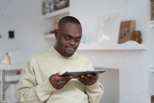 Man with Down syndrome using tablet photo