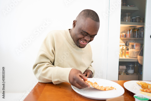 Man with Down syndrome eating pizza