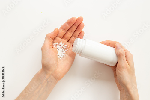 Tableau sur toile Woman applying baby talcum powder on hand. Skin care cosmetic