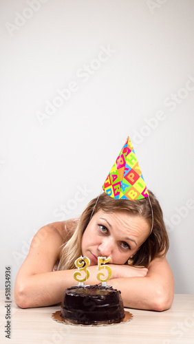 a woman celebrates her birthday alone. beautiful sad woman clebrating her birthday alone photo