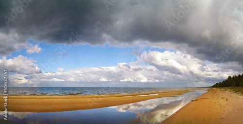 Fototapeta Naklejka Na Ścianę i Meble -  Panoramic view of the beach on the coast of Latvia during summer on cloudy day